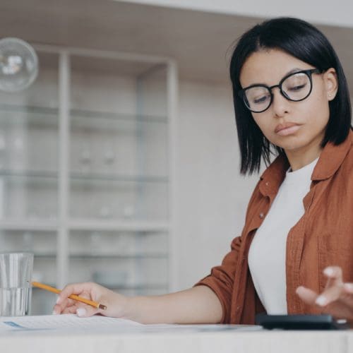 agriculture - svg xml charset utf 8  3Csvg 20xmlns 3D http 3A 2F 2Fwww - Agriculture - photo Focused female in glasses counts expenses on calculator, managing project budget, sitting at desk agriculture - svg xml charset utf 8  3Csvg 20xmlns 3D http 3A 2F 2Fwww - Agriculture